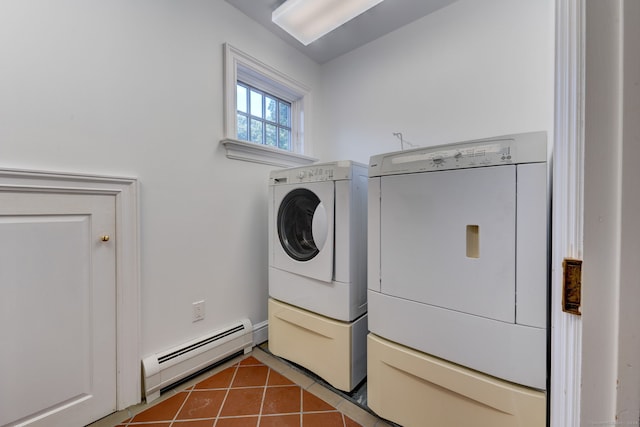 washroom with baseboard heating, washing machine and dryer, and tile patterned floors