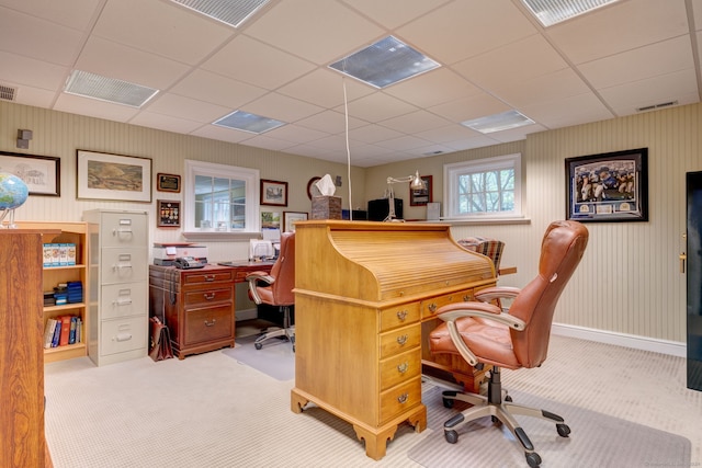 office with a paneled ceiling and light carpet