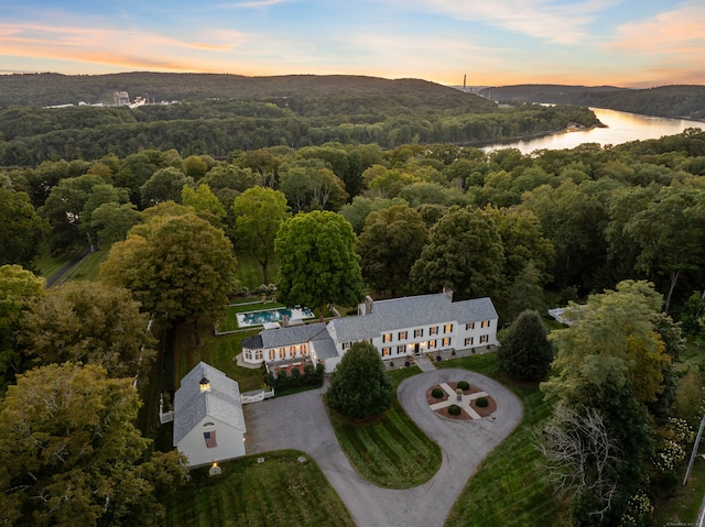 aerial view at dusk with a water view