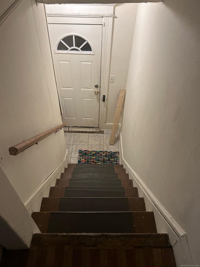 staircase featuring tile patterned flooring