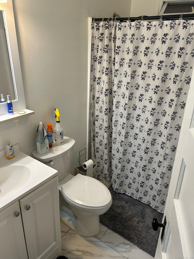 bathroom with tile patterned flooring, vanity, and toilet