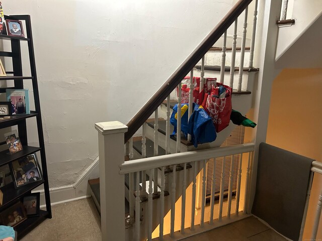 staircase with tile patterned floors