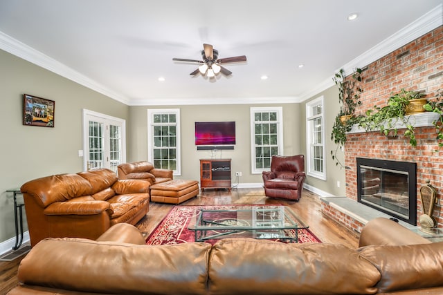 living room with ceiling fan, a fireplace, and hardwood / wood-style floors