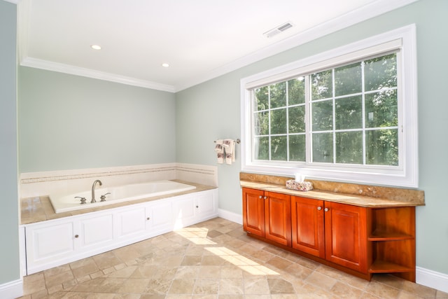 bathroom with a bathing tub, ornamental molding, and tile patterned floors