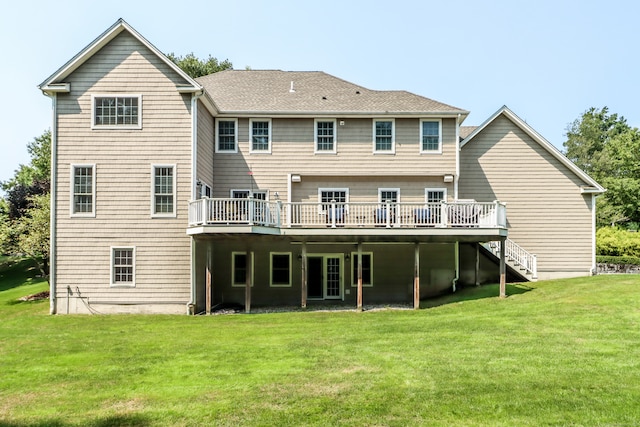 back of house featuring a lawn and a wooden deck