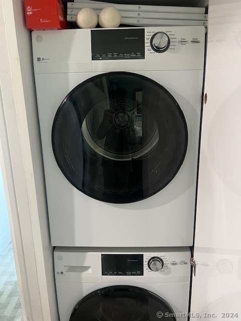 washroom featuring stacked washer and dryer