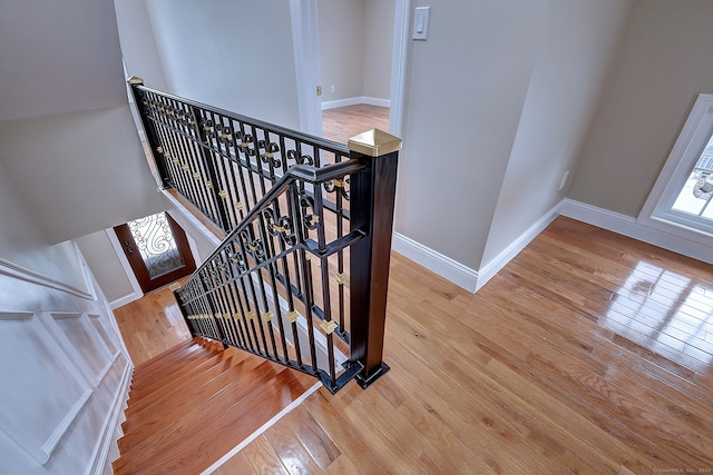 stairs with hardwood / wood-style floors