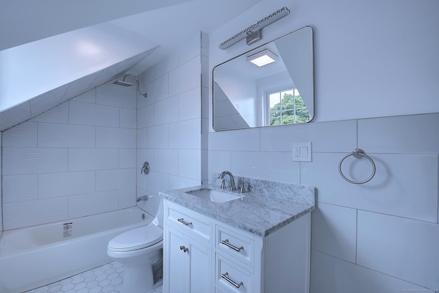 full bathroom featuring tiled shower / bath, tile patterned floors, vanity, tile walls, and toilet