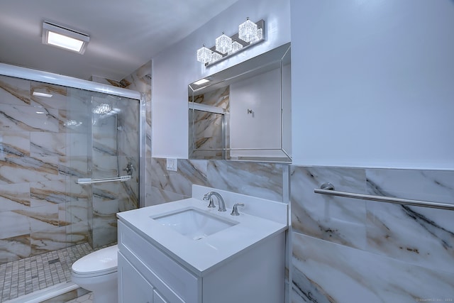 bathroom featuring a shower with shower door, tile walls, toilet, and vanity