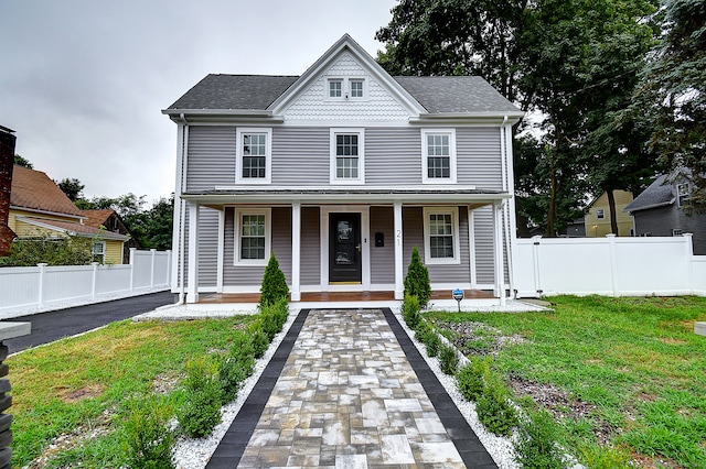 view of front of home with a porch and a front lawn