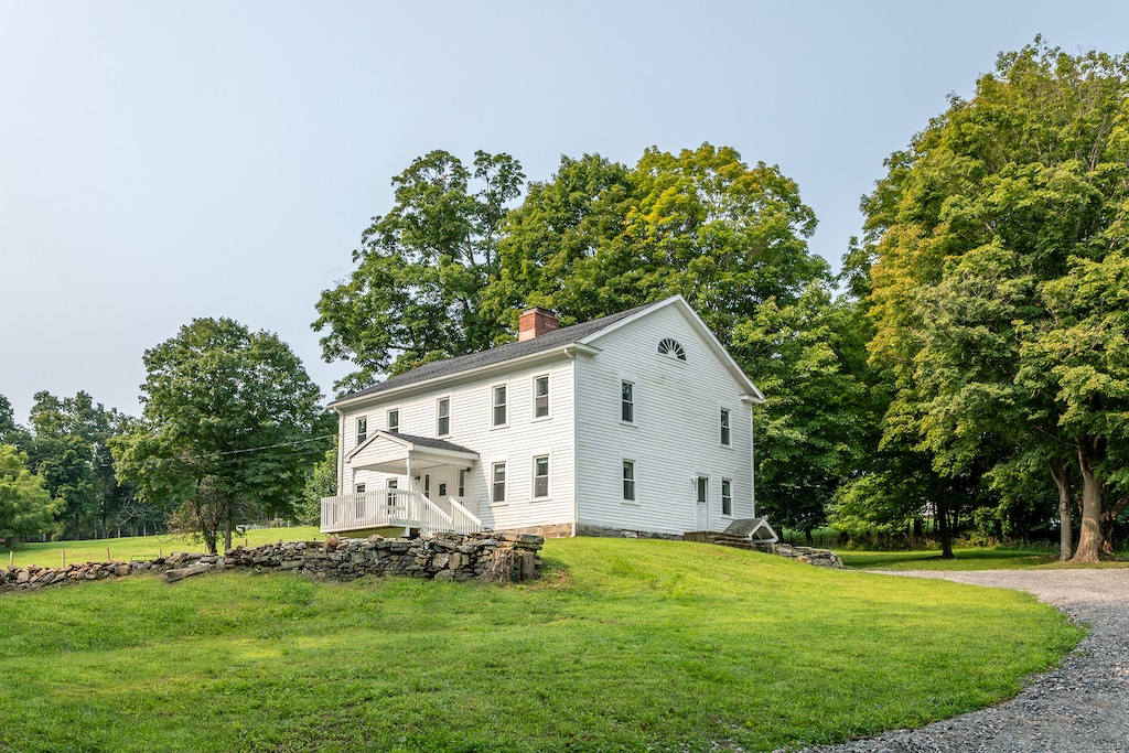 view of side of home featuring a yard