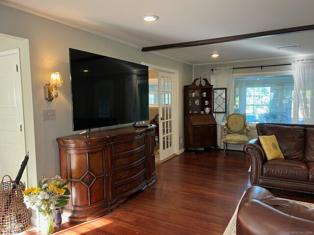 living room featuring ornamental molding and dark hardwood / wood-style floors