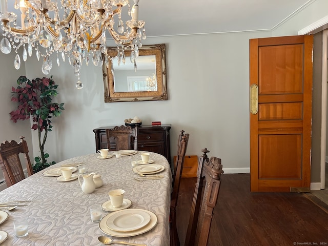 dining space with dark wood-type flooring and crown molding