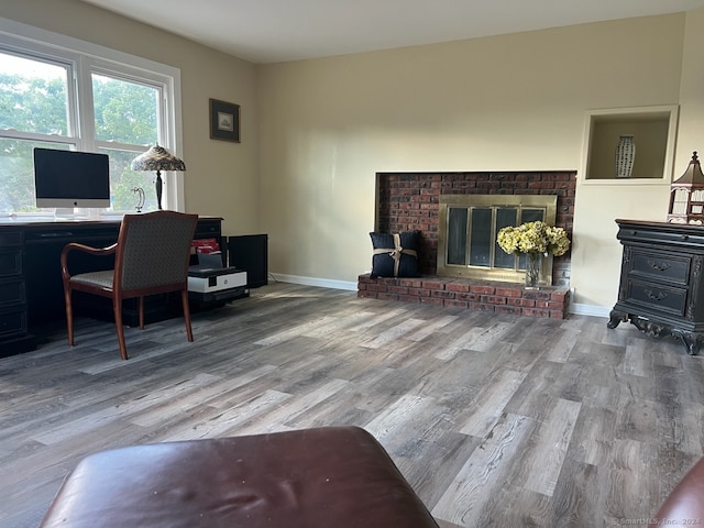 office space featuring hardwood / wood-style floors and a fireplace