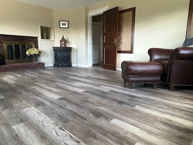 sitting room with hardwood / wood-style floors and a fireplace