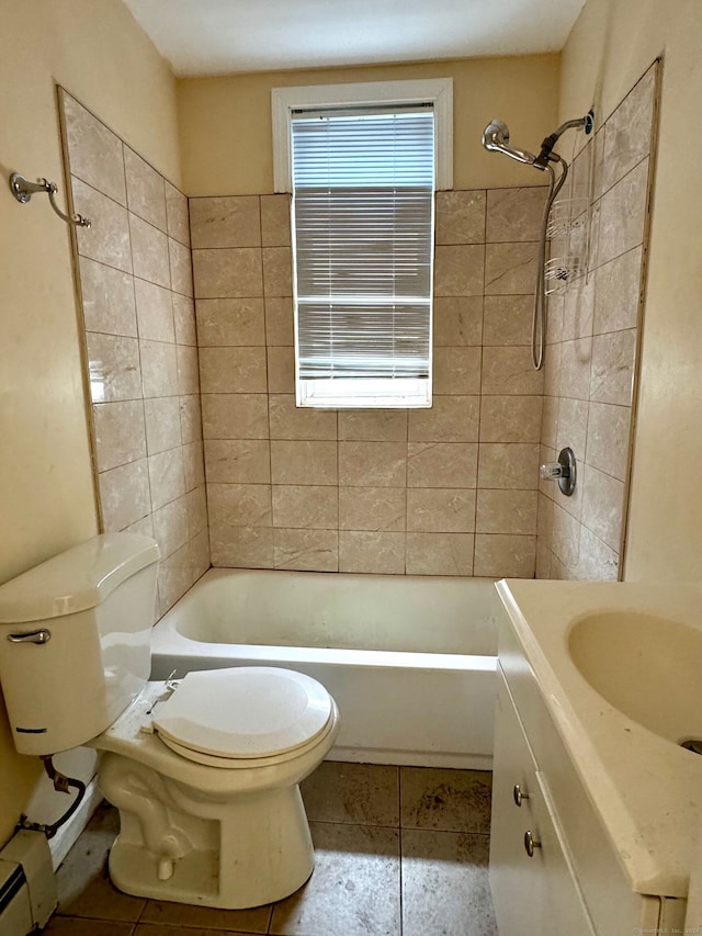 full bathroom featuring tiled shower / bath, a baseboard radiator, tile patterned flooring, vanity, and toilet