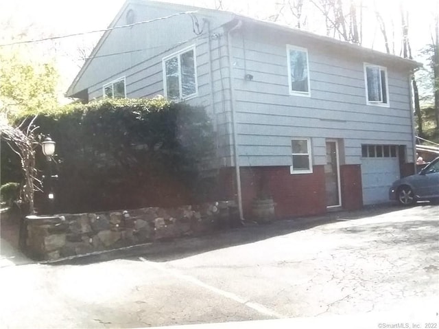 view of side of home featuring a garage