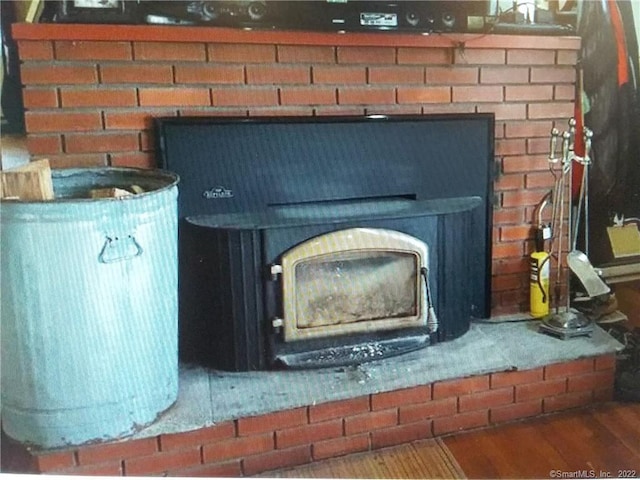 details featuring wood finished floors and a wood stove