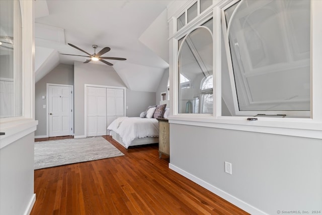 unfurnished bedroom featuring lofted ceiling, dark hardwood / wood-style floors, and ceiling fan