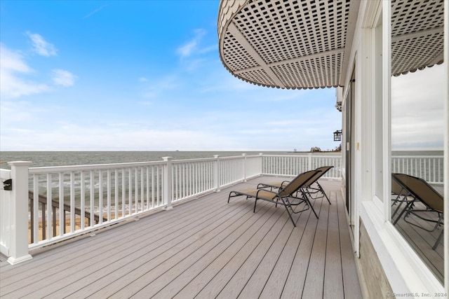 wooden terrace with a water view and a beach view