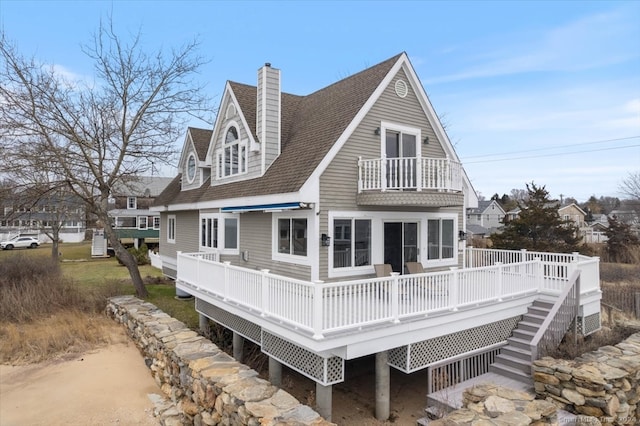 back of house featuring a wooden deck