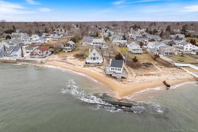 birds eye view of property featuring a water view and a beach view