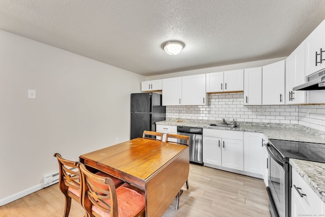 kitchen with sink, black fridge, decorative backsplash, dishwasher, and range with electric stovetop