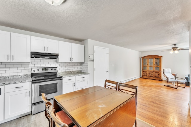 kitchen featuring stainless steel range with electric cooktop, ceiling fan, white cabinets, and light wood-type flooring