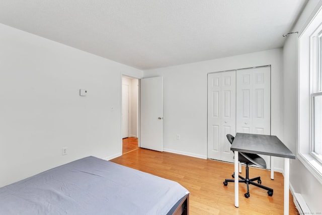 bedroom with a closet and light hardwood / wood-style floors