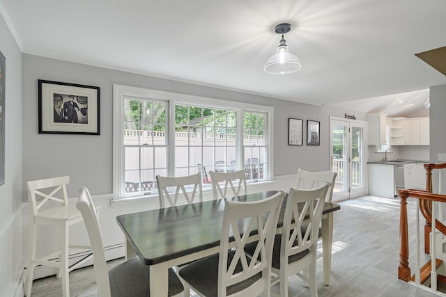 dining area with french doors, ornamental molding, light hardwood / wood-style flooring, and sink