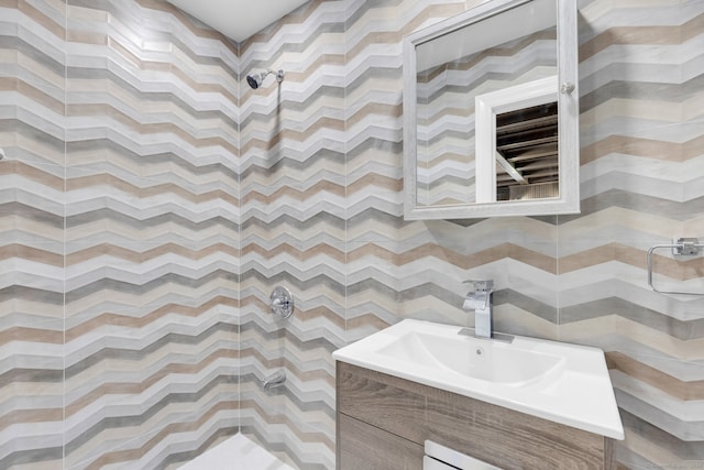 bathroom featuring a shower and vanity