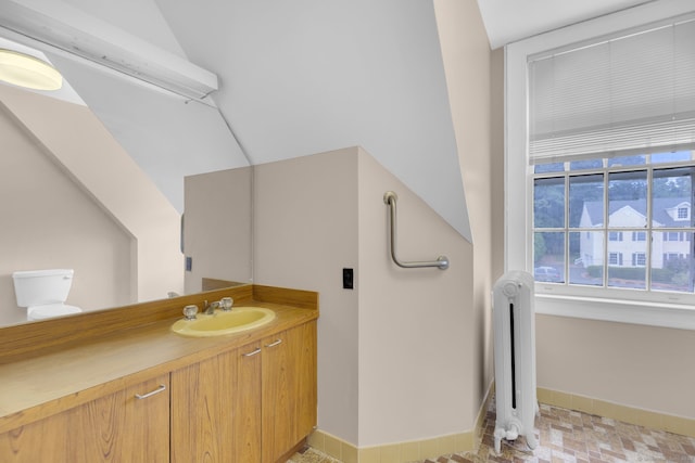 bathroom with tile patterned floors, vanity, and radiator