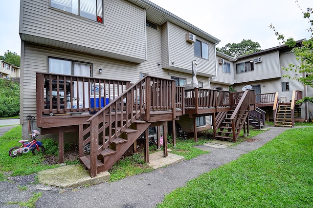 rear view of property featuring a lawn and a deck