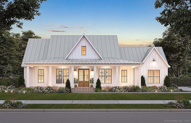 modern farmhouse style home featuring a porch and a lawn