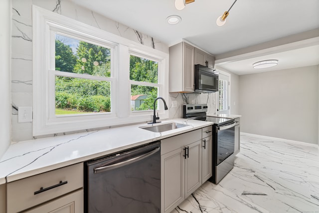 kitchen with stainless steel appliances, plenty of natural light, and sink