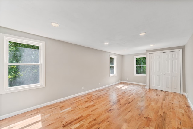 unfurnished bedroom with light wood-type flooring