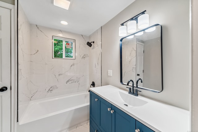 bathroom featuring tiled shower / bath combo and vanity