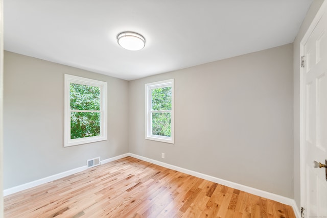 spare room featuring light wood-type flooring