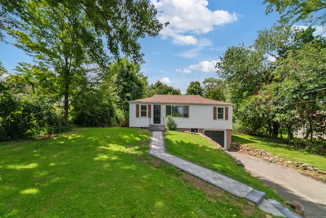 view of front of home with a front lawn and a garage