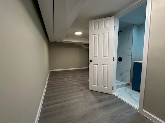 bathroom with a shower and hardwood / wood-style floors