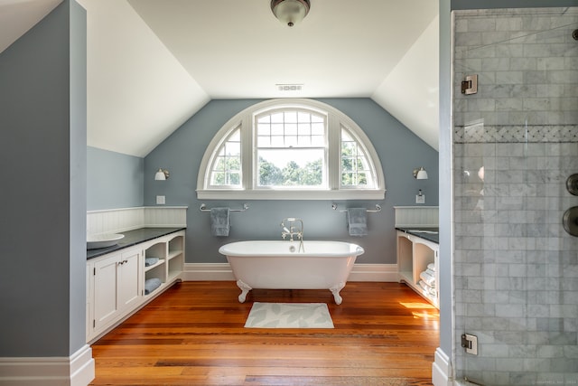 bathroom with vanity, separate shower and tub, wood-type flooring, and vaulted ceiling