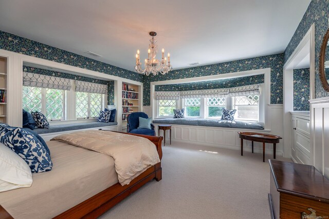 carpeted bedroom with a notable chandelier