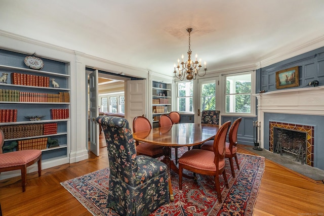 51 Ferry Bridge Rd, Washington, CT 06793 - dining room featuring a chandelier, built in shelves, healthy amount of natural light, and crown molding