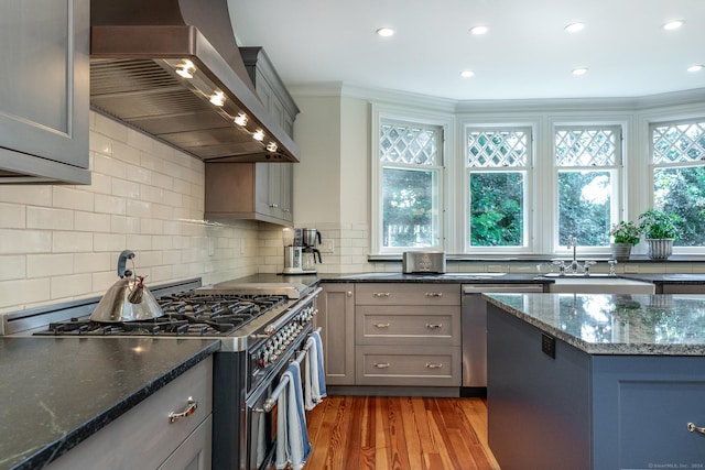 51 Ferry Bridge Rd, Washington, CT 06793 - kitchen with wall chimney range hood, stainless steel appliances, gray cabinetry, ornamental molding, and light wood finished floors
