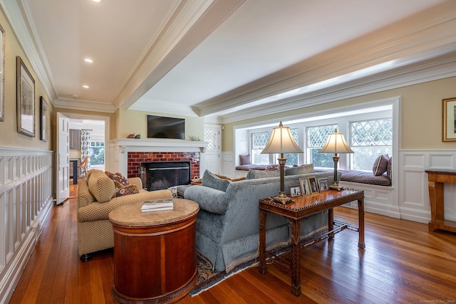 51 Ferry Bridge Rd, Washington, CT 06793 - living area with crown molding, wood-type flooring, a brick fireplace, a decorative wall, and wainscoting