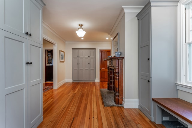 interior space with light wood-type flooring and crown molding