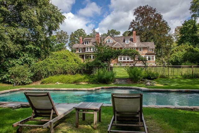 view of pool with a lawn