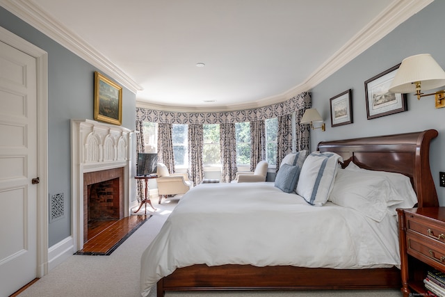 bedroom with ornamental molding and carpet