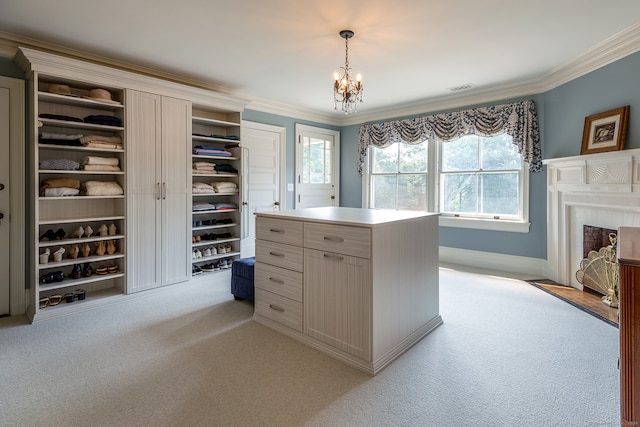 spacious closet with light colored carpet and a chandelier