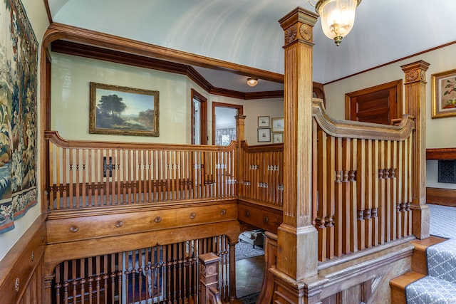 stairs with ornamental molding and ornate columns